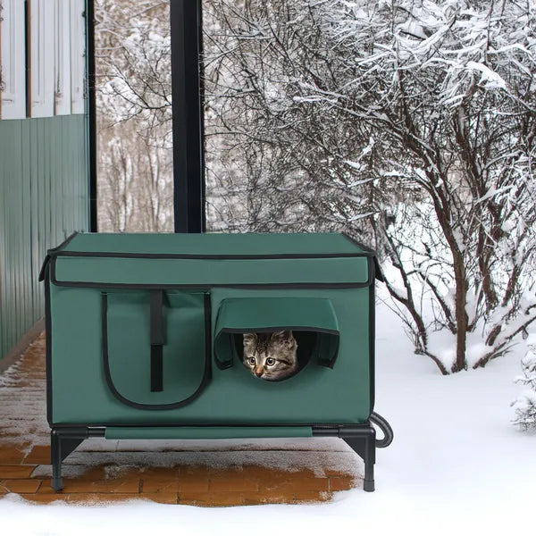 Heated outdoor cat house set up on a snowy porch