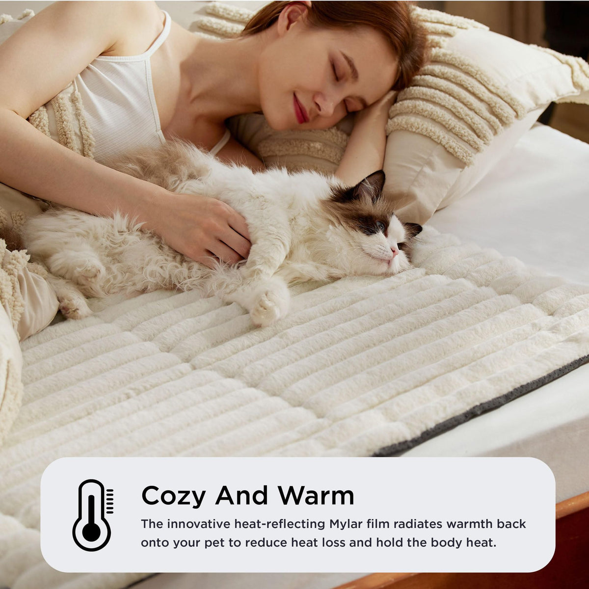 Cat sleeping on the self-warming mat on a bed